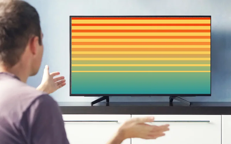 Television displaying colorful vertical and horizontal lines, indicating a faulty T-Con board fixed by OnePlus TV repair in Hyderabad.