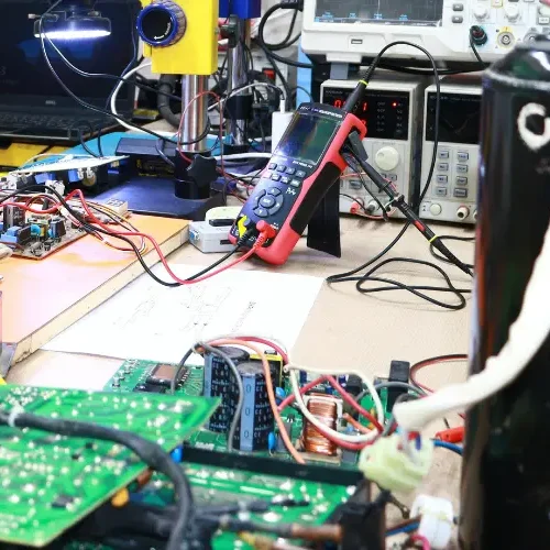 Damaged TV power supply board caused by voltage fluctuations, being inspected by the best TV repair services in Hyderabad.