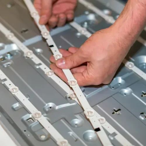 Replacing burnt-out LED backlight strips to fix a TV with sound but no picture during a Samsung TV repair in Hyderabad.
